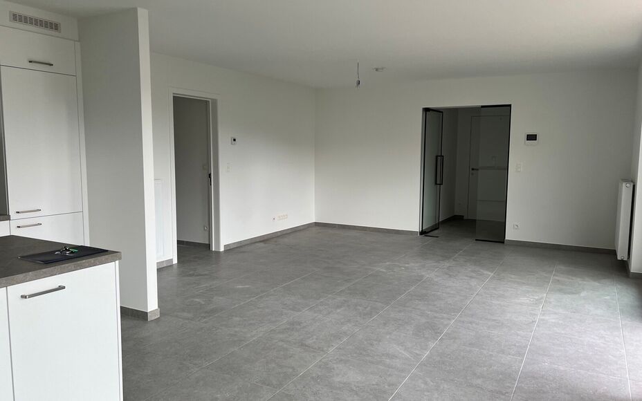 Dit nieuwbouw appartement gelegen in het centrum van Opwijk biedt alle comfort om te wonen op een unieke locatie in het groen. 

Bij binnenkomst begeeft u zich doorheen de ruime inkomhal, via een kwaliteitsvolle afgewerkte glazen deur richting de woonkame